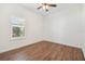 Bright bedroom features hardwood floors, large window with shutter, crown molding, and recessed lighting, offering serene comfort at 1819 Bella Casa Ct, Tampa, FL 33618