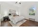 A bright bedroom features a queen bed, ceiling fan, and window with plantation shutters at 1819 Bella Casa Ct, Tampa, FL 33618