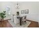 Dining space with wood floors, a chandelier, a large window, and modern decor for elegant dining at 1819 Bella Casa Ct, Tampa, FL 33618