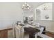 Formal dining room featuring modern chandeliers, wood floors, and sophisticated decor for elegant dining at 1819 Bella Casa Ct, Tampa, FL 33618