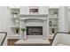 Elegant fireplace with white mantel, built-in shelves, and decorative accessories at 1819 Bella Casa Ct, Tampa, FL 33618