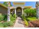 Inviting front entrance with meticulously landscaped walkway, decorative columns and a beautiful entry door at 1819 Bella Casa Ct, Tampa, FL 33618