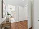 Hallway with view to bathroom, wood floors, and access to rooms at 1819 Bella Casa Ct, Tampa, FL 33618