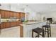 Gourmet kitchen featuring wood cabinets, stainless steel appliances, granite countertops, and an eat-in island at 1819 Bella Casa Ct, Tampa, FL 33618
