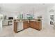 Bright, open-concept kitchen with wood cabinets, granite countertops, stainless steel dishwasher, and bar seating at 1819 Bella Casa Ct, Tampa, FL 33618