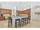 Open kitchen featuring granite countertops, wooden cabinetry, stainless steel appliances, and bar stool seating at 1819 Bella Casa Ct, Tampa, FL 33618
