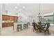 A spacious kitchen and breakfast nook area features wood cabinets and a breakfast table with a large window at 1819 Bella Casa Ct, Tampa, FL 33618