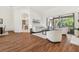 Bright living room with wood floors, white sofa, and view to outdoor patio at 1819 Bella Casa Ct, Tampa, FL 33618