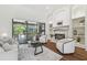 Cozy living room with fireplace, built-in shelves, and sliding glass doors to patio at 1819 Bella Casa Ct, Tampa, FL 33618