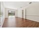 Spacious living room with hardwood floors and sliding door access to the screened-in pool offers a seamless indoor-outdoor flow at 1819 Bella Casa Ct, Tampa, FL 33618