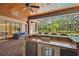 Spacious outdoor kitchen and bar area overlooking the pool and lush landscaping at 1819 Bella Casa Ct, Tampa, FL 33618