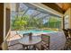 Relaxing poolside view with an outdoor dining area and lush tropical greenery at 1819 Bella Casa Ct, Tampa, FL 33618