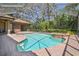 Lushly landscaped pool and patio area with spa and screened enclosure at 1819 Bella Casa Ct, Tampa, FL 33618