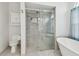Well-lit bathroom featuring a glass shower, toilet, and soaking tub at 23211 Lucerne Pl, Land O Lakes, FL 34639