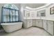 Bathroom featuring a soaking tub, stained glass window, and double sink vanity at 23211 Lucerne Pl, Land O Lakes, FL 34639