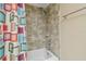 Bathroom featuring a shower-tub combo with decorative tile and a colorful shower curtain at 23211 Lucerne Pl, Land O Lakes, FL 34639