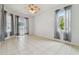 Bright bedroom features tile floors, neutral walls, ceiling fan, and sliding door leading to a patio at 23211 Lucerne Pl, Land O Lakes, FL 34639