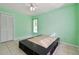 Bedroom with light green walls, tile floor, ceiling fan and built-in bed platform with storage at 23211 Lucerne Pl, Land O Lakes, FL 34639