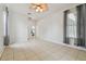 Spacious bedroom with tile floors, ceiling fan, and access to an en suite bathroom at 23211 Lucerne Pl, Land O Lakes, FL 34639