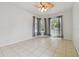 Bright and airy bedroom with tile floors and sheer curtains over the windows at 23211 Lucerne Pl, Land O Lakes, FL 34639