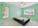 Bright bedroom featuring tile floors, ceiling fan, and a platform bed with built-in storage at 23211 Lucerne Pl, Land O Lakes, FL 34639