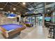 Well-appointed game room with pool tables, TVs, and a view of the outdoors at 23211 Lucerne Pl, Land O Lakes, FL 34639
