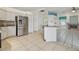Eat-in kitchen features stainless steel appliances, an island and tile floors which extend into the living room at 23211 Lucerne Pl, Land O Lakes, FL 34639
