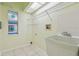 Laundry room with tile flooring, shelving, a utility sink, and stained glass window at 23211 Lucerne Pl, Land O Lakes, FL 34639
