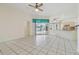 Spacious living room with tile floors, ceiling fans, and sliding glass doors to the backyard pool at 23211 Lucerne Pl, Land O Lakes, FL 34639