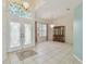 Bright open-plan living space with tile flooring, decorative chandeliers, and lots of natural light at 23211 Lucerne Pl, Land O Lakes, FL 34639