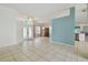 Bright open-plan living space with tile flooring, decorative chandeliers, and lots of natural light at 23211 Lucerne Pl, Land O Lakes, FL 34639
