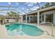 A covered pool features easy access with multiple entry points and backyard views at 23211 Lucerne Pl, Land O Lakes, FL 34639