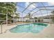 Inviting in-ground pool with screened enclosure and views of the backyard at 23211 Lucerne Pl, Land O Lakes, FL 34639