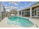 A covered pool features easy access with multiple entry points and backyard views at 23211 Lucerne Pl, Land O Lakes, FL 34639