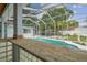 View of the sparkling pool and outdoor space from the poolside bar with wood counter at 23211 Lucerne Pl, Land O Lakes, FL 34639