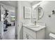 Bright bathroom with marble vanity top, sleek fixtures, and ample natural light at 2400 Winding Creek Blvd # 2-201, Clearwater, FL 33761