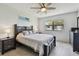 Comfortable bedroom featuring a large bed, ceiling fan, and night stands at 2400 Winding Creek Blvd # 2-201, Clearwater, FL 33761