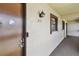 Close-up of condo unit entrance featuring the unit number, a secure door, and wall texture at 2400 Winding Creek Blvd # 2-201, Clearwater, FL 33761