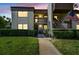 Inviting condo exterior at dusk with well-maintained landscaping, multiple units, and visible unit numbers at 2400 Winding Creek Blvd # 2-201, Clearwater, FL 33761
