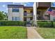 Inviting condo exterior with well-maintained landscaping, multiple units, and visible unit numbers at 2400 Winding Creek Blvd # 2-201, Clearwater, FL 33761