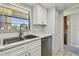 This bright kitchen features marble countertops and a stainless steel sink at 2400 Winding Creek Blvd # 2-201, Clearwater, FL 33761