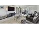 Cozy living room with modern furniture, entertainment center, and natural light from sliding doors at 2400 Winding Creek Blvd # 2-201, Clearwater, FL 33761