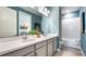 Bathroom featuring double sinks, white countertop, vanity, bathtub, and coordinated towels at 29477 Velletri Ln, Wesley Chapel, FL 33543