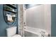 Modern bathroom featuring bathtub, shower, and decorative shelves at 29477 Velletri Ln, Wesley Chapel, FL 33543