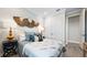 Comfortable bedroom with stylish bed, decorative wall hangings, and side tables at 29477 Velletri Ln, Wesley Chapel, FL 33543