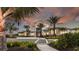 Beautiful community center showcasing lush landscaping, palm trees, and a welcoming entrance at 29477 Velletri Ln, Wesley Chapel, FL 33543