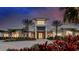 Elegant community center featuring a modern architectural design with palm trees and manicured landscaping at 29477 Velletri Ln, Wesley Chapel, FL 33543