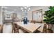 Open-concept dining area with view into kitchen, stylish decor, and a large painting adding to the ambiance at 29477 Velletri Ln, Wesley Chapel, FL 33543