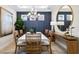 Elegant dining room with a modern chandelier, decorative wall, and stylish furnishings at 29477 Velletri Ln, Wesley Chapel, FL 33543