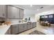 Modern kitchen with gray cabinets, stainless steel appliances, and a view into the dining room at 29477 Velletri Ln, Wesley Chapel, FL 33543